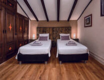 a bedroom with a wood floor